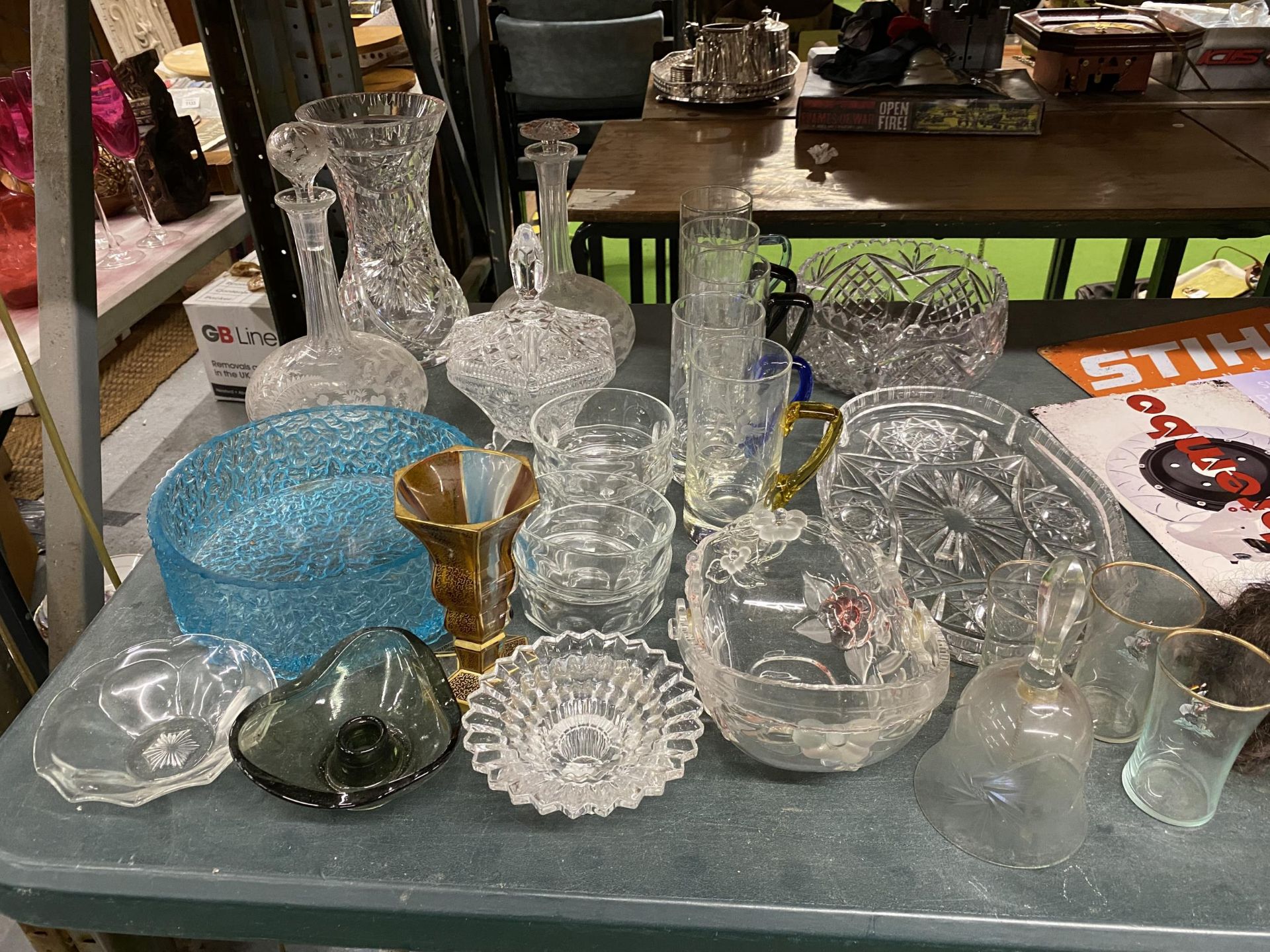 A LARGE QUANTITY OF GLASSWARE TO INCLUDE VASES, DECANTERS, BOWLS, GLASSES, ETC