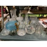 A LARGE QUANTITY OF GLASSWARE TO INCLUDE VASES, DECANTERS, BOWLS, GLASSES, ETC