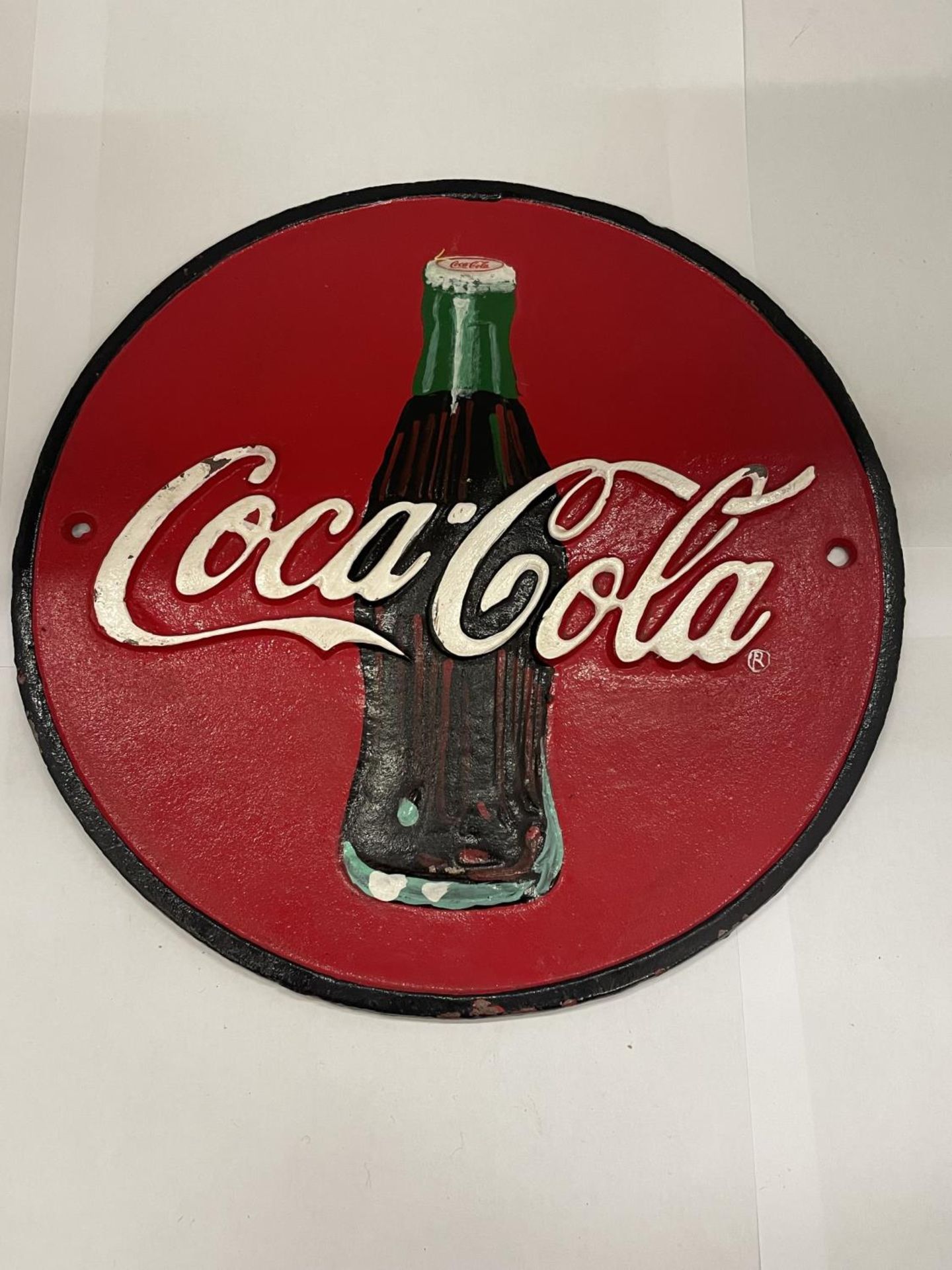 A CAST 'COCA-COLA' SIGN DIAMETER 24CM