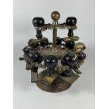 AN UNUSUAL 19TH CENTURY BRASS TWO TIER REVOLVING STAMP HOLDER WITH ORIGINAL EBONY HANDLED STAMPS,