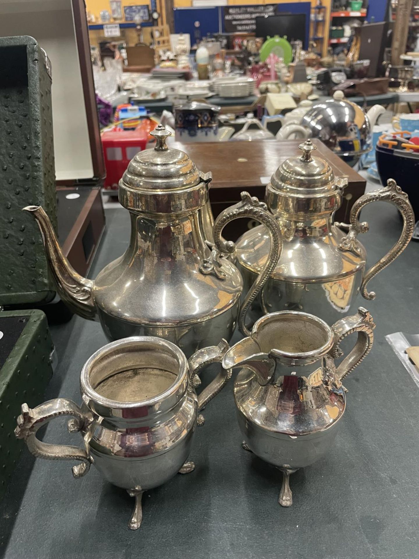 A SILVER PLATED TEASET TOINCLUDE COFFEE POT, TEAPOT, CREAM JUG AND SUGAR BOWL