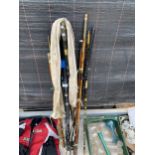 AN ASSORTMENT OF VINTAGE SPLIT CANE FISHING RODS AND MODERN CARBON FIBRE RODS