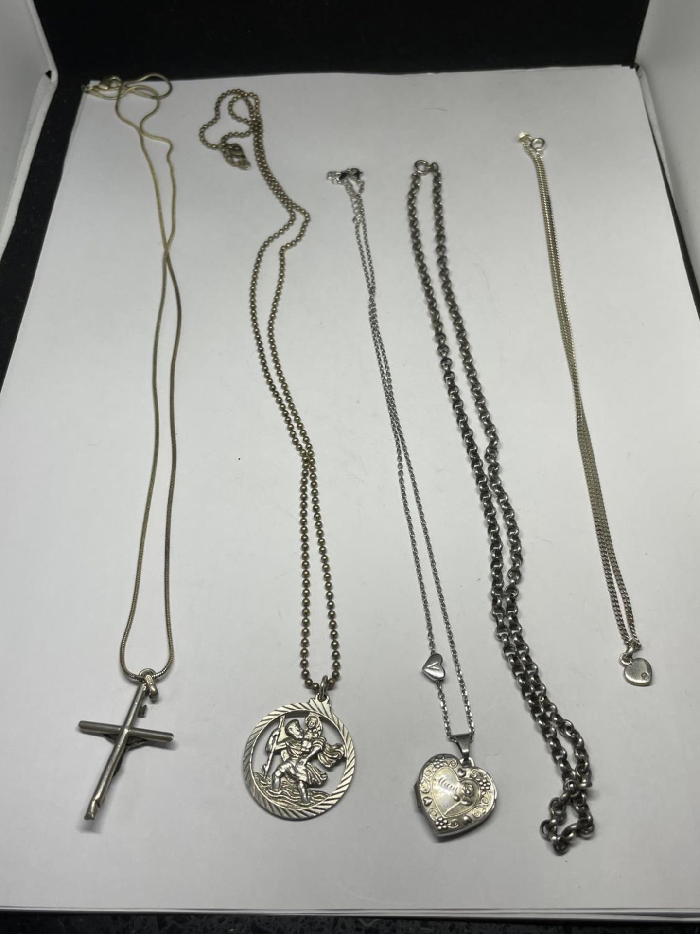 FIVE SILVER NECKLACES FOUR WITH PENDANTS