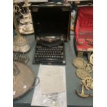 A VINTAGE REMINGTON COMPACT PORTABLE TYPEWRITER COMPLETE WITH CASE AND INSTRUCTIONS