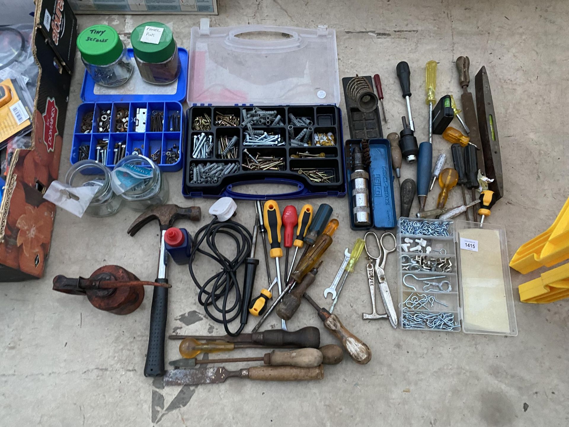 AN ASSORTMENT OF TOOLS AND HARDWARE TO INCLUDE SCREWS, A HAMMER, A SOLDERING IRON AND SCREW