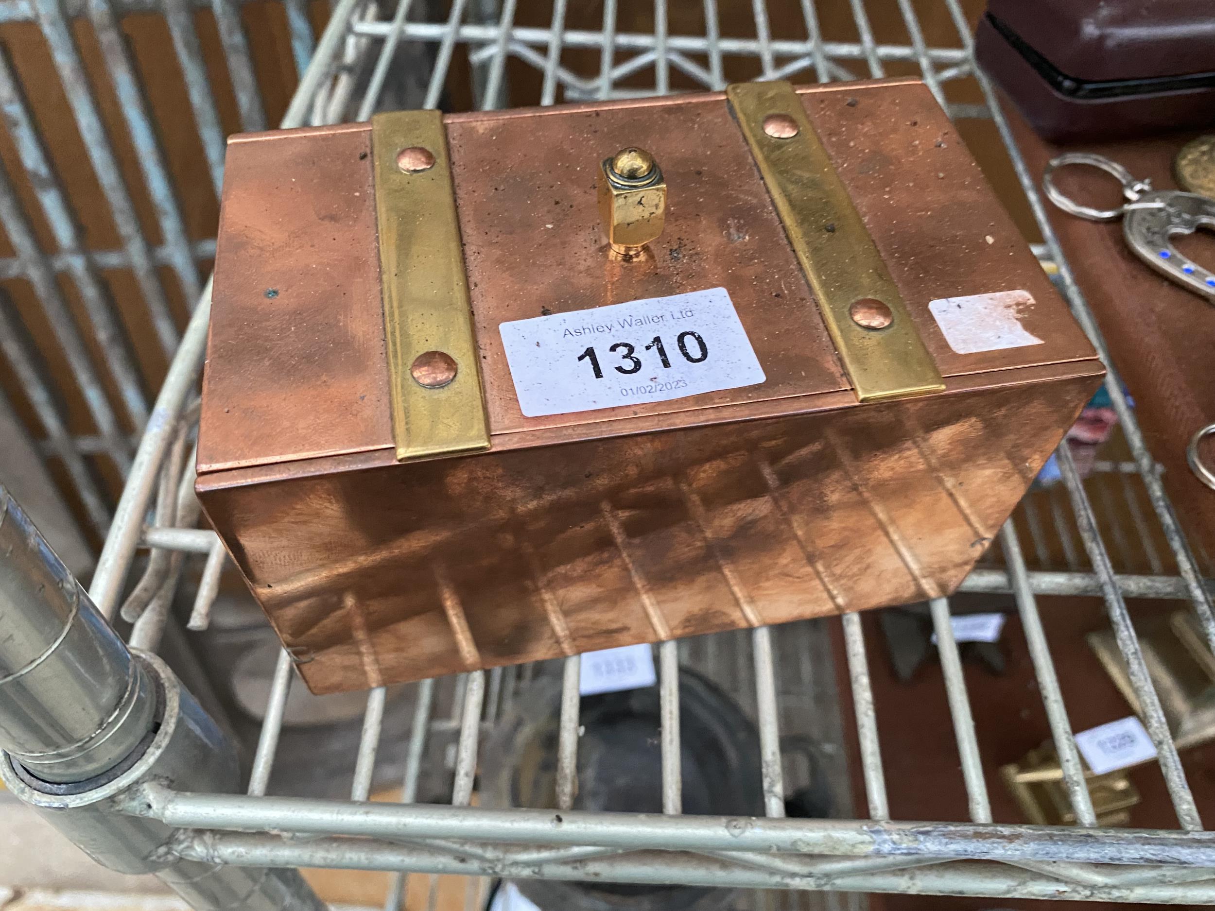 A HEAVY COPPER LIDDED BOX WITH BRASS BANDING