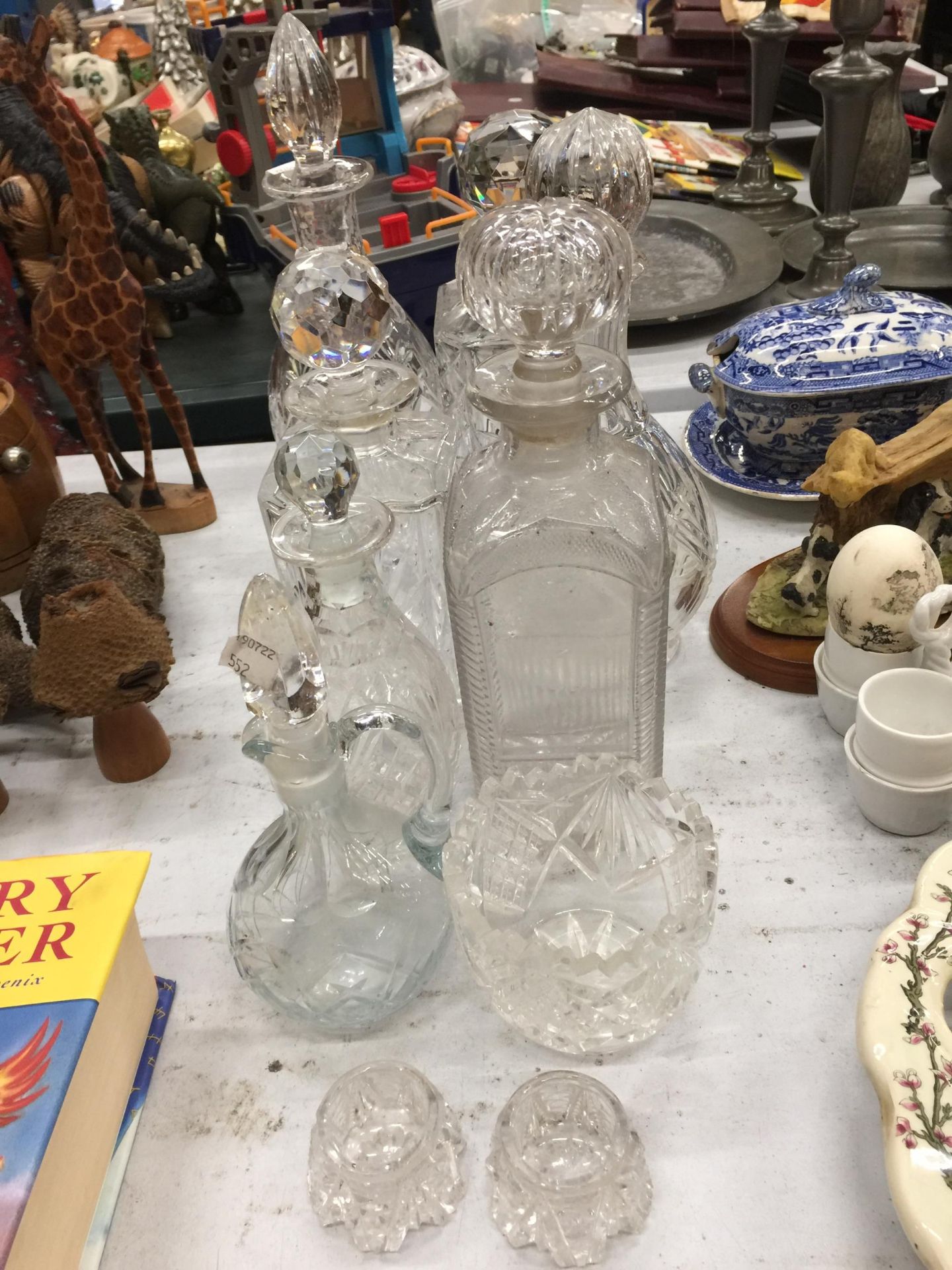 A QUANTITY OF GLASSWARE DECANTERS PLUS AN OIL BOTTLE AND TEALIGHT HOLDERS