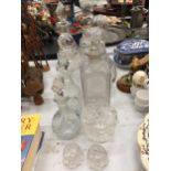 A QUANTITY OF GLASSWARE DECANTERS PLUS AN OIL BOTTLE AND TEALIGHT HOLDERS