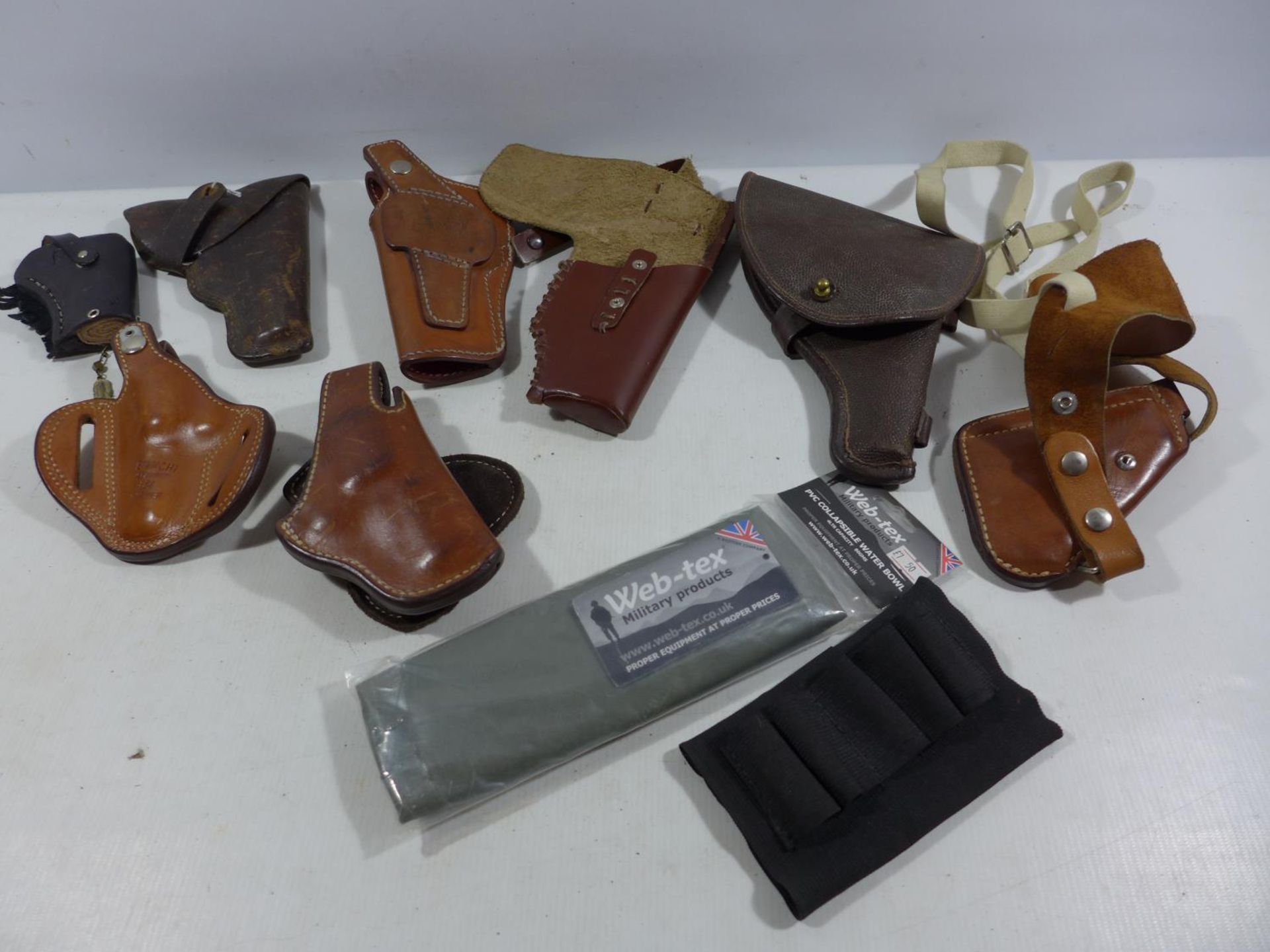 EIGHT ASSORTED LEATHER HOLSTERS ETC