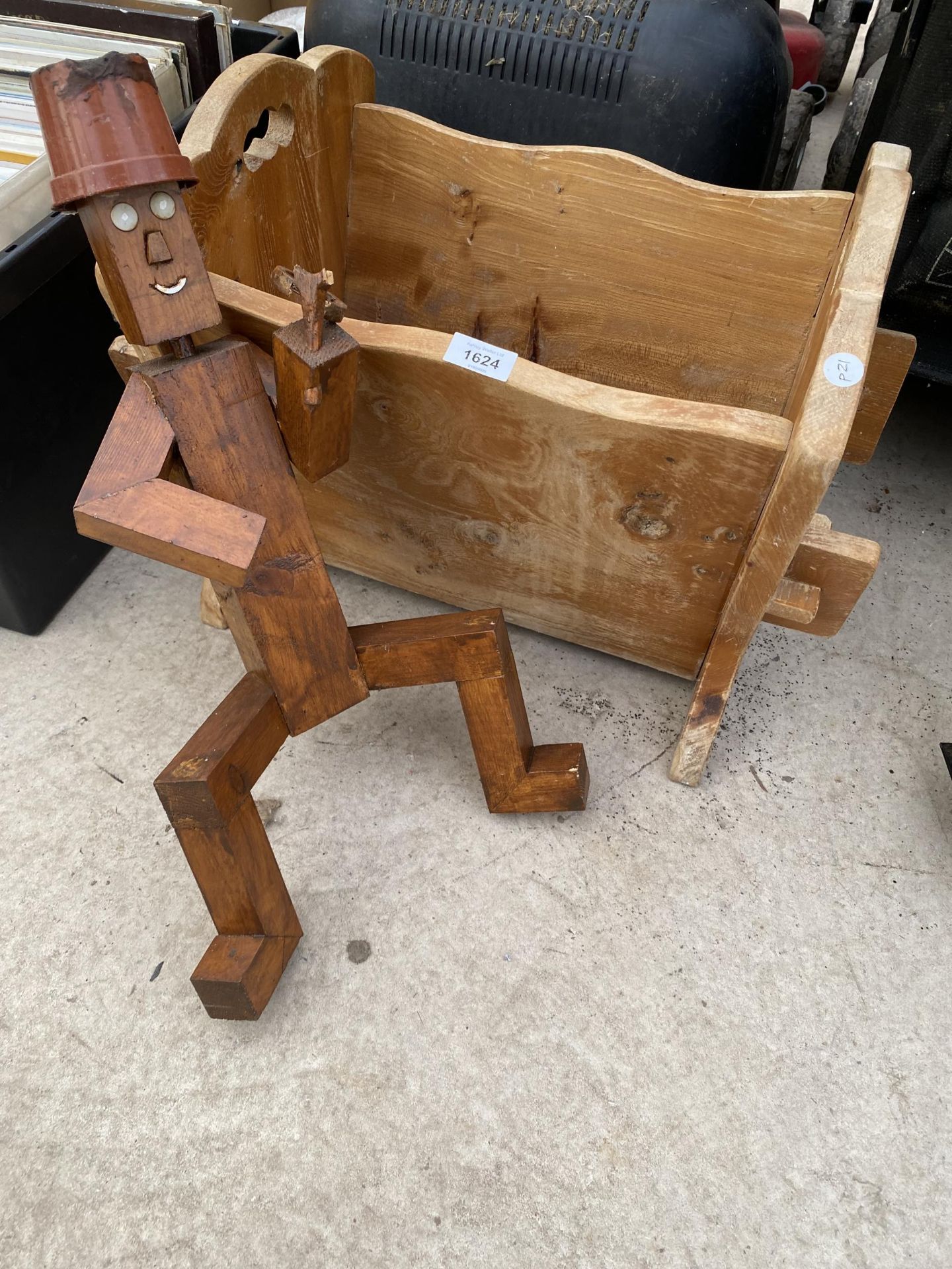 A WOODEN PLANT TROUGH AND A WOODEN GARDEN FIGURE