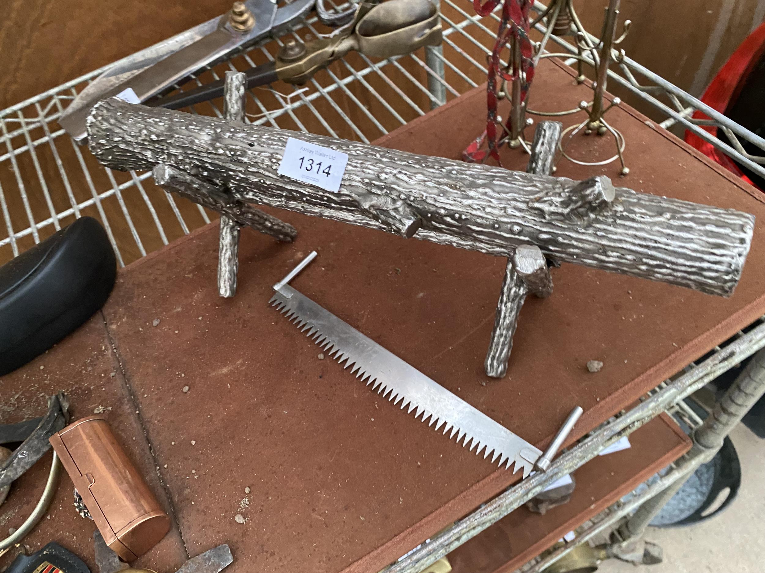 A MINITURE SILVER PLATED LOG STAND, LOG AND CROSS CUT SAW