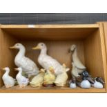 AN ASSORTMENT OF CERAMIC AND WOODEN DUCKS