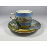 A 19TH CENTURY HAND PAINTED PORCELAIN CUP AND SAUCER WITH LAKE & CASTLE SCENE, CROSS/WING MARK TO