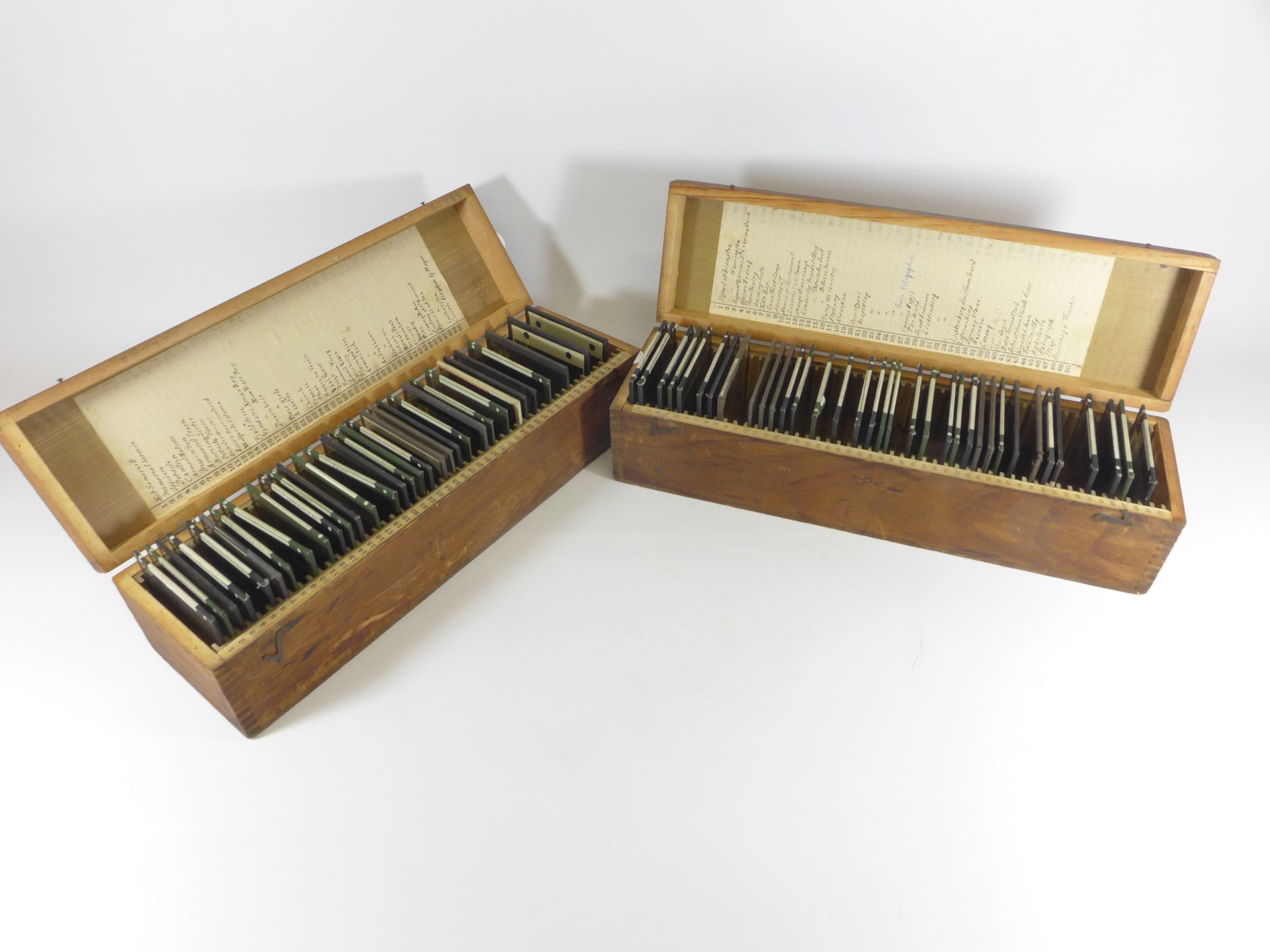 TWO BOXES CONTAINING SIXTY-FOUR BLACK AND WHITE PHOTOGRAPHIC SLIDES RELATING TO THE BOER WAR