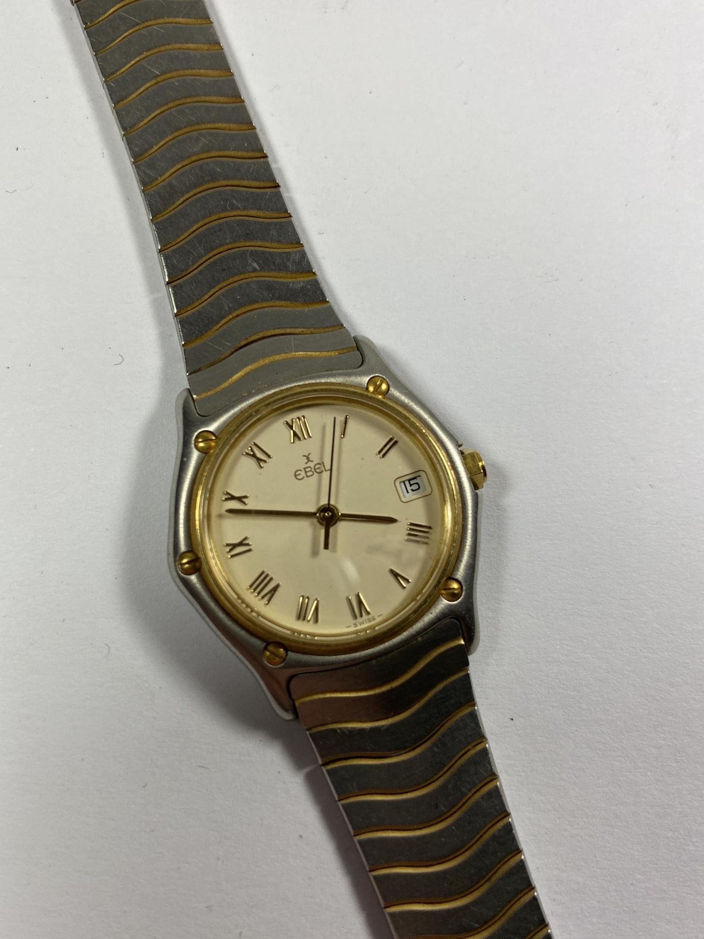 A LADIES 'EBEL' STAINLESS STEEL DATE WATCH
