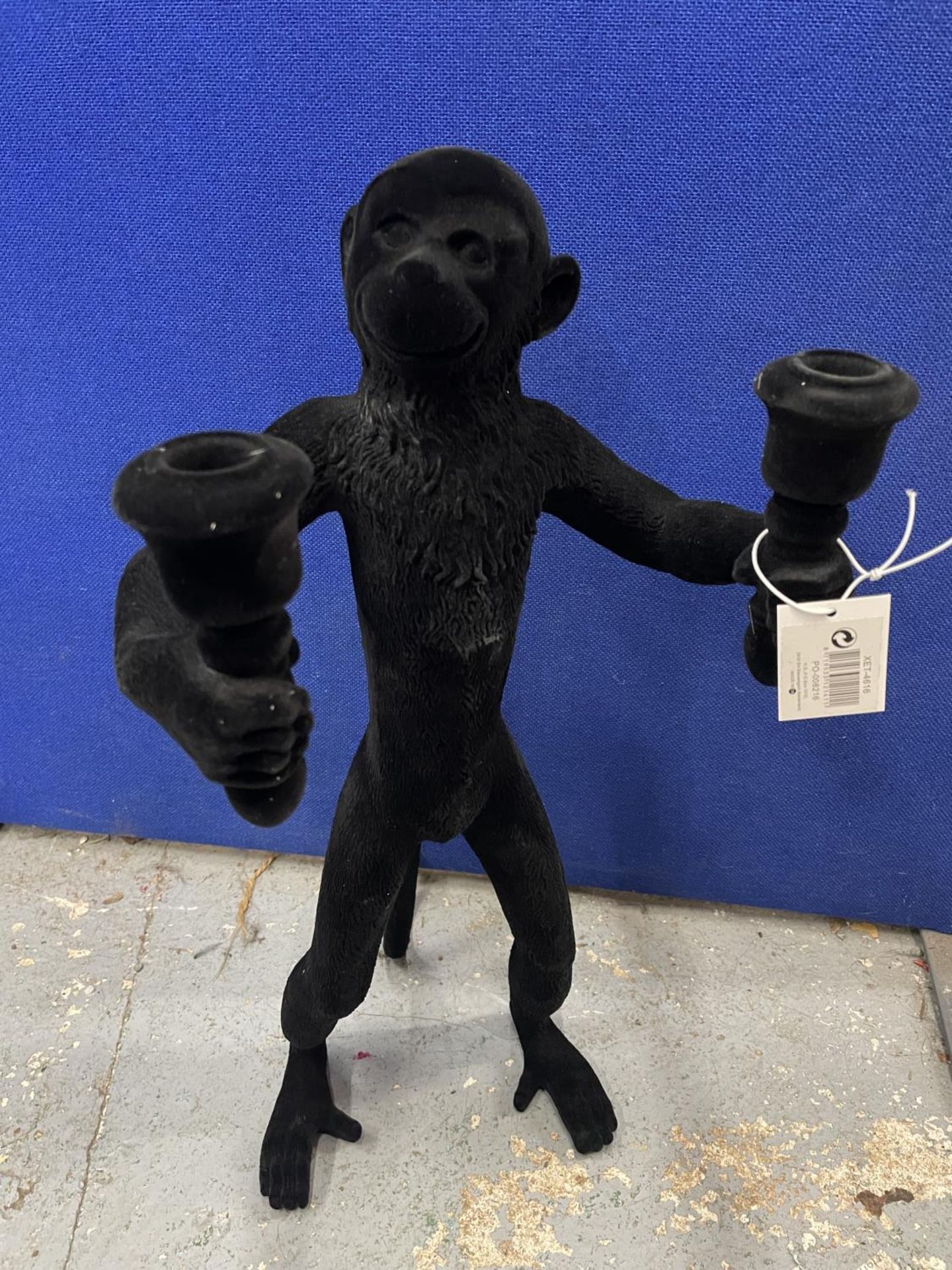 A FLOCK COVERED 'MONKEY' CANDLE HOLDER HEIGHT 53CM