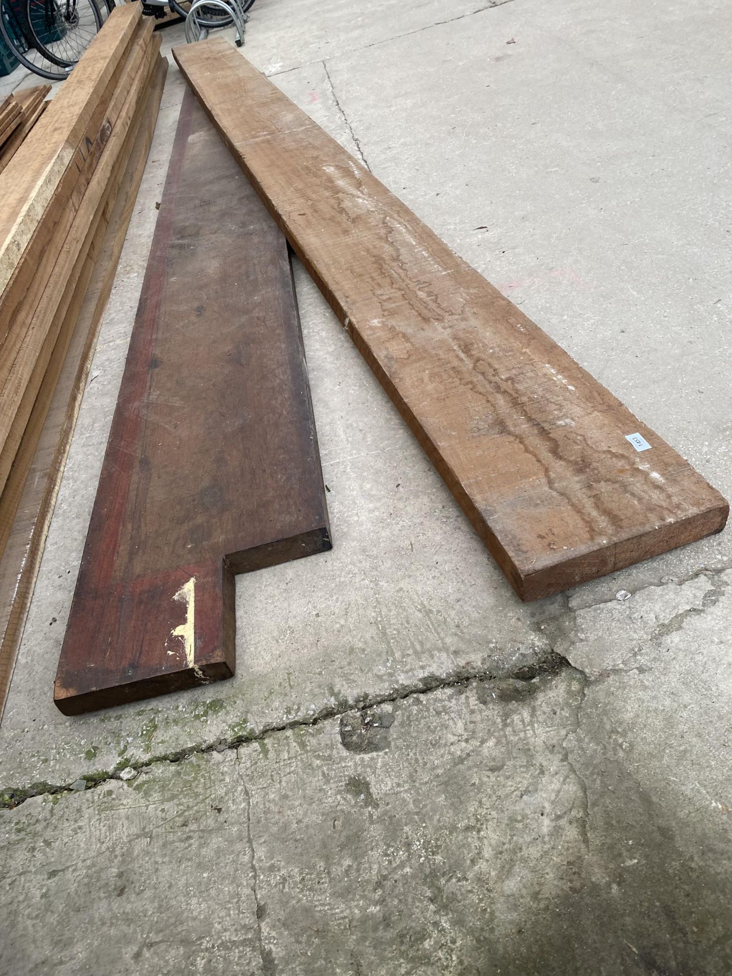 A LENGTH OF IROKO TIMBER (L:14FT 2" W:12" T:2.5") AND A FURTHER PIECE OF MAHOGANY (L:10FT 6" W:16"