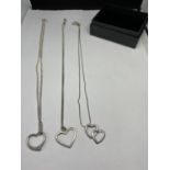THREE SILVER NECKLACES WITH HEART PENDANTS IN A PRESENTATION BOX