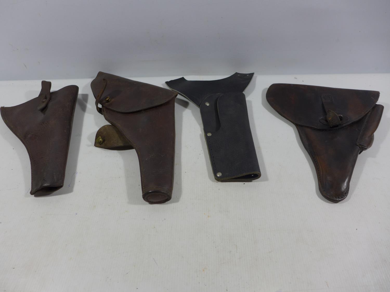 FOUR LEATHER HOLSTERS TO INCLUDE MILITARY EXAMPLE