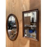 TWO OAK FRAMED BEVELED EDGE WALL MIRRORS TO INCLUDE A RECTANGLUR AND AN OVAL MIRROR