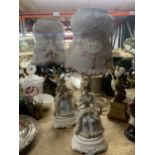 A PAIR OF CERAMIC TABLE LAMPS WITH FIGURES TO THE BASE AND CERAMIC SHADES HEIGHT 36CM
