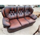 A MODERN OXBLOOD 'SAXON LEATHER' THREE SEATER SETTEE WITH BUTTON-BACK