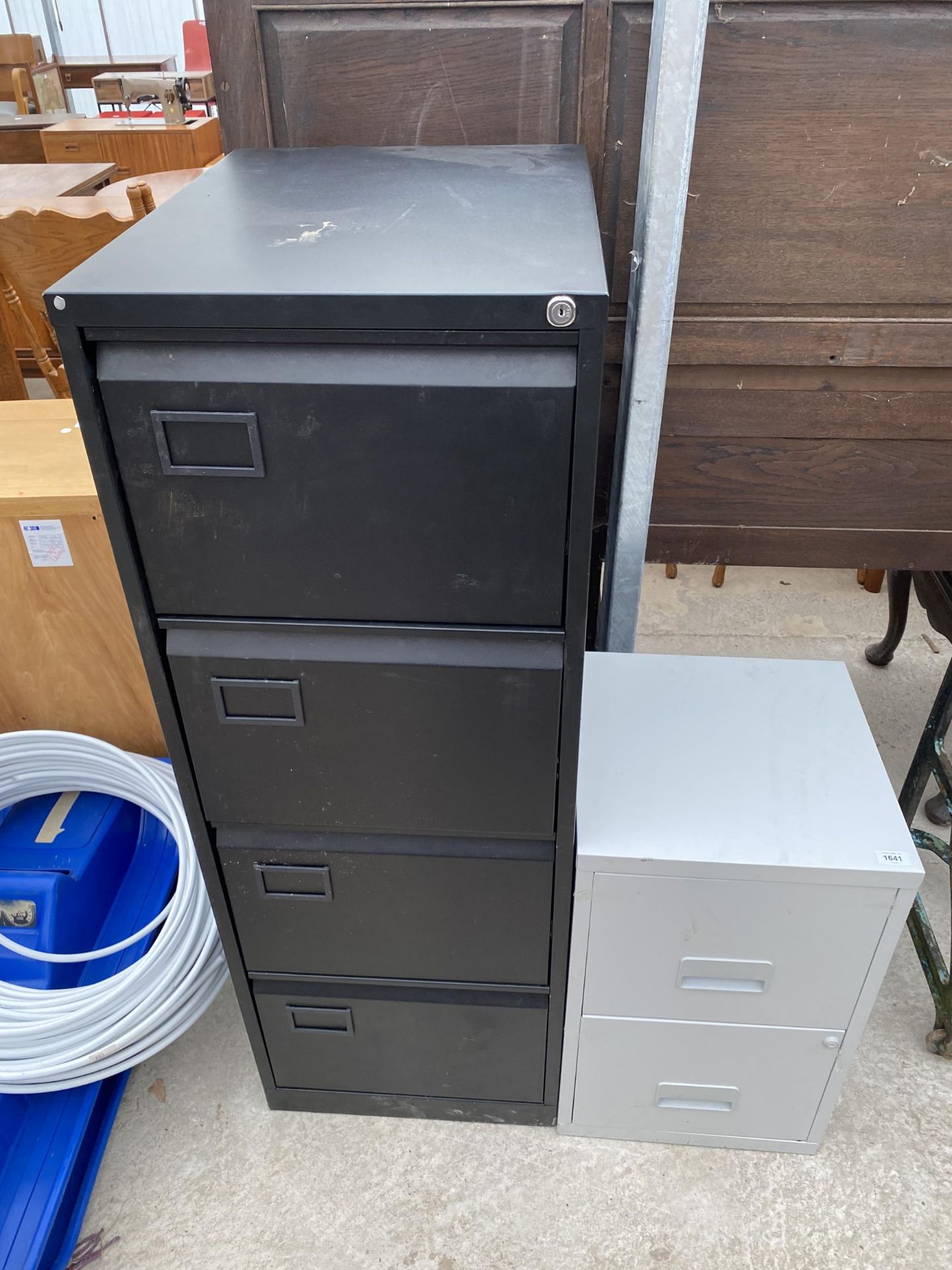 A FOUR DRAWER METAL FILING CABINET AND A FURTHER TWO DRAWER METAL FILING CABINET