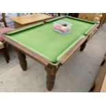 A SMALL SNOOKER TABLE (64X34") ON OAK BASE WITH TURNED LEGS, COMPLETE WITH SNOOKER BALLS AND
