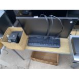 A DELL COMPUTER MONITOR, SPEAKERS AND A KEYBOARD