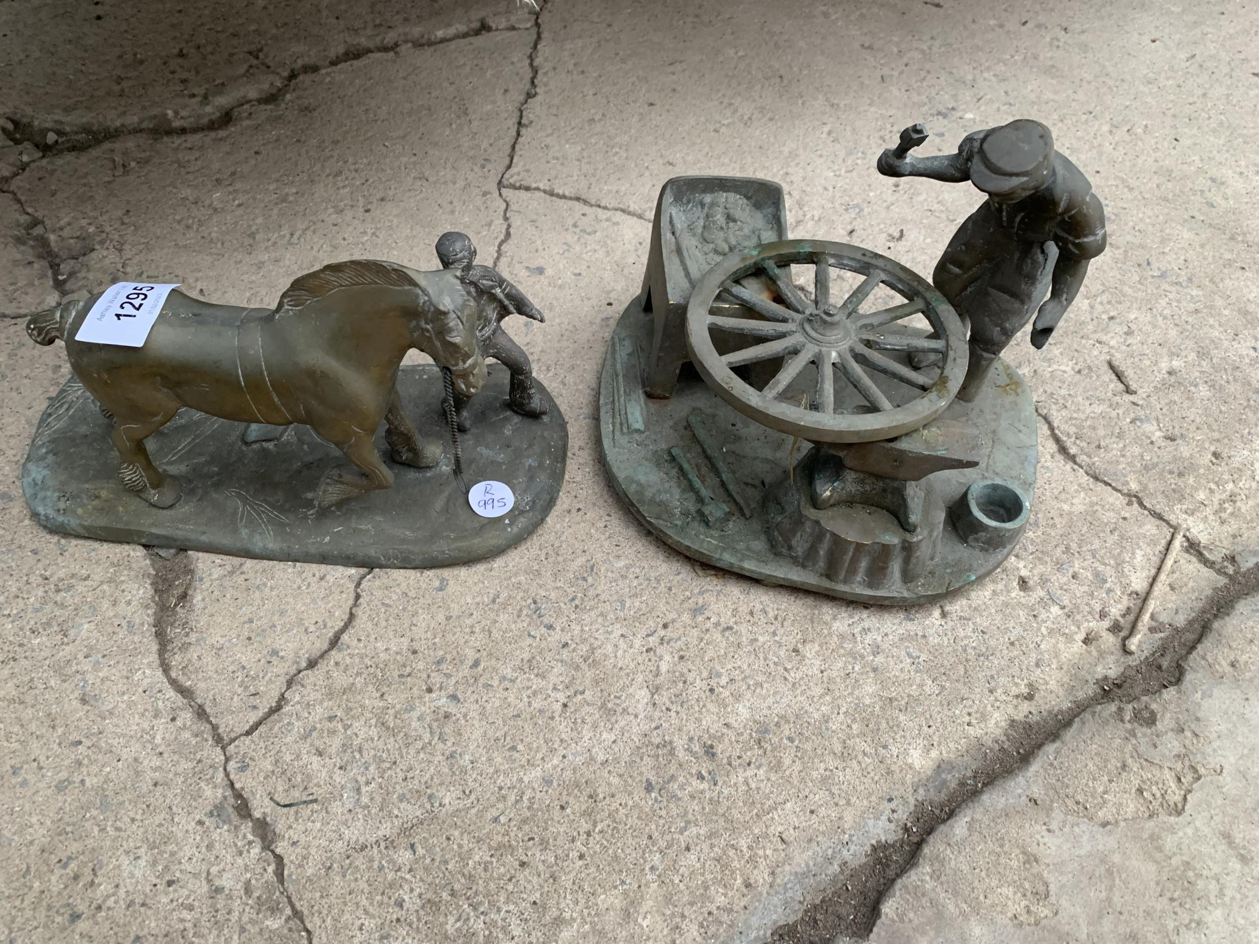 TWO BRASS ORNAMENTS DEPICTING A BLACKSMITH AND A MAN WITH A HORSE