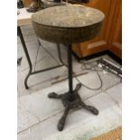 A CIRCULAR TOPPED BARSTOOL WITH CAST METAL BASE WITH PAW FEET