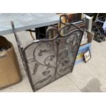 A DECORATIVE WROUGHT IRON FIRE SCREEN