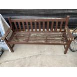 A WOODEN THREE SEATER GARDEN BENCH