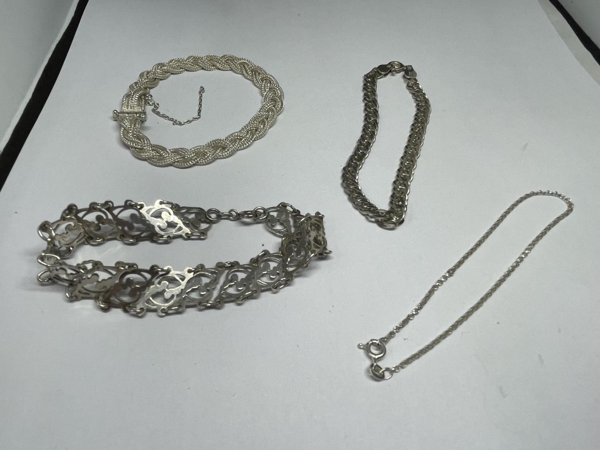 FOUR VARIOUS SILVER BRACELETS