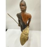 A WOODEN CARVED FIGURE OF AN AFRICAN WARRIOR WITH SPEAR AND SHIELD HEIGHT 30CM