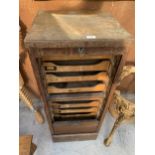 A VINTAGE WOODEN FILING TRAY CABINET WITH TAMBOUR FRONT AND NINE INTERNAL TRAYS