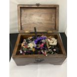 A VINTAGE MAHOGANY BOX CONTAINING A QUANTOITY OF COSTUME JEWELLERY TO INCLUDE NECKLACES,