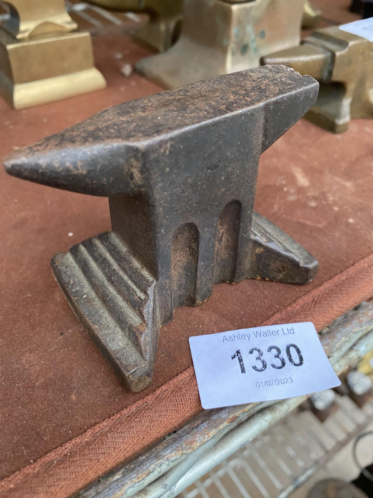 A MINITURE CAST IRON ANVIL