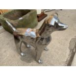 A SMALL STAINLESS STEEL DOG FIGURE