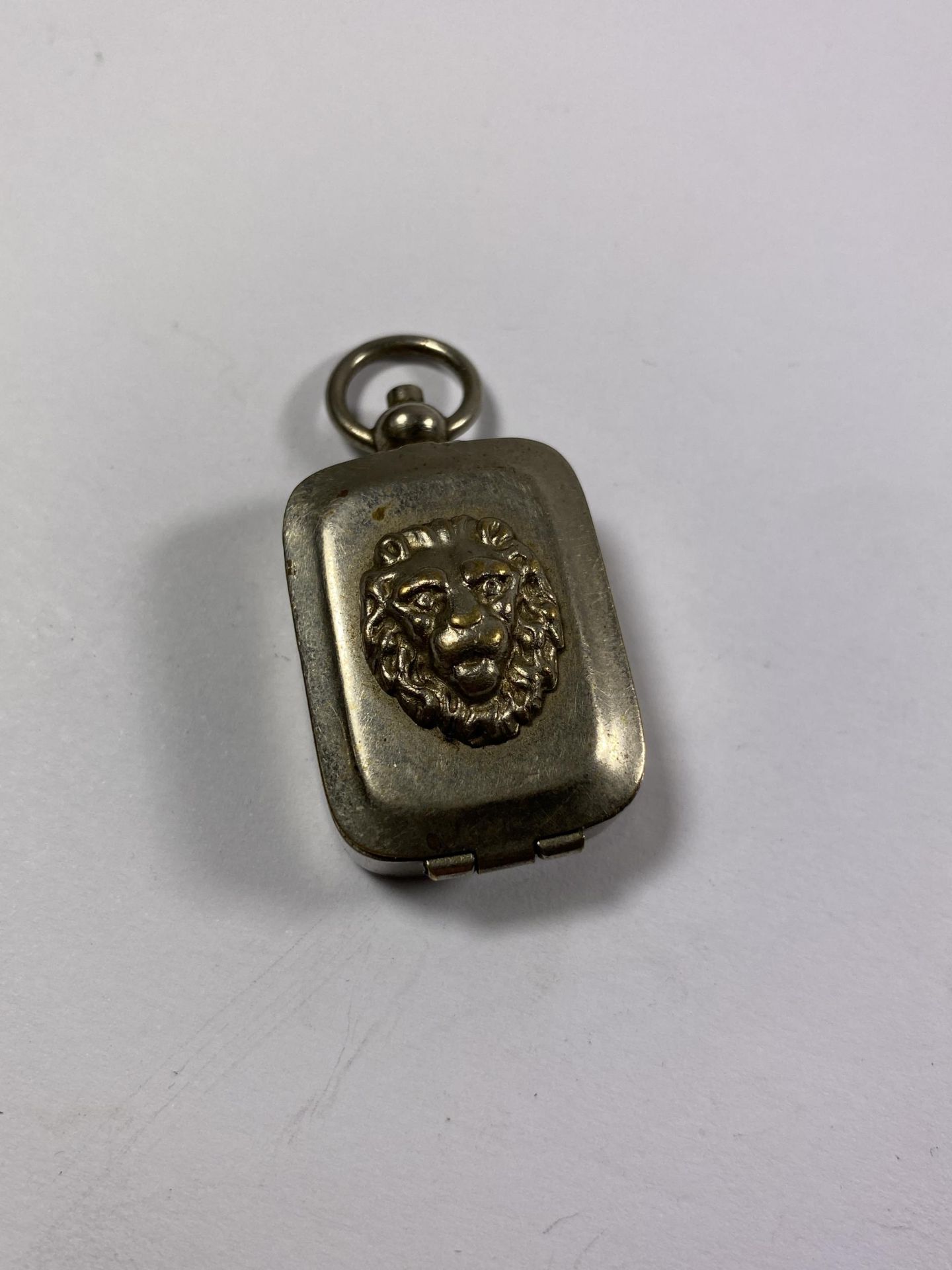 A METAL FOB WITH INK SEAL INSIDE