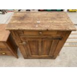 A RUSTIC PINE KITCHEN CUPBOARD WITH SINGLE DOOR AND DRAWER, 31" WIDE