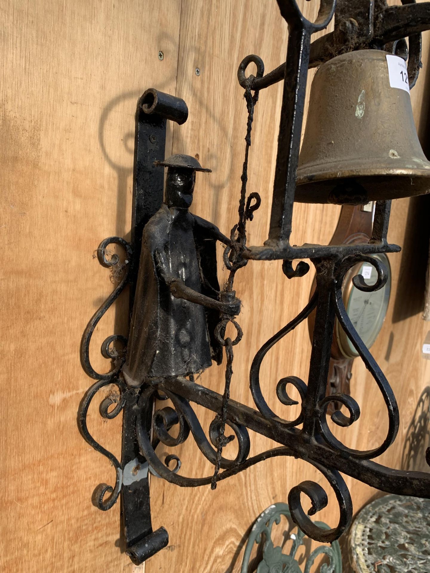 A VINTAGE WROUGHT IRON WALL HANGING BELL WITH MALE FIGURE - Image 2 of 2