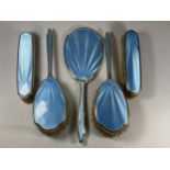 A FIVE PIECE HALLMARKED SILVER BACKED & BLUE GUILLOCHE ENAMEL DRESSING SET COMPRISING TWO HAIR