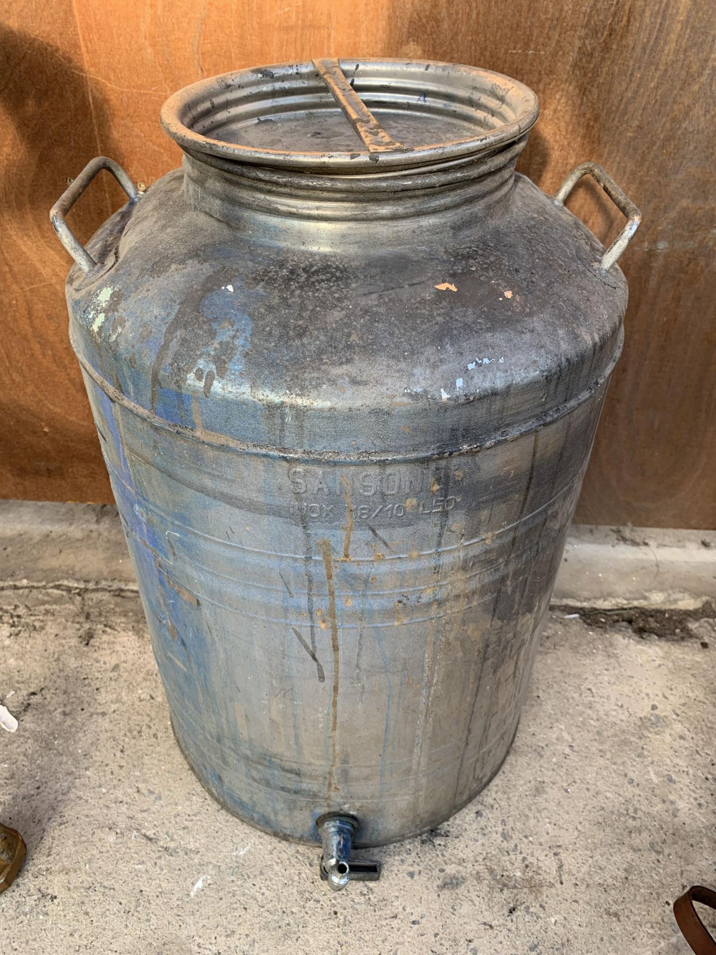 A GALVANISED WATER TANK WITH LOWER TAP