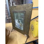 A VINTAGE BRASS FIRE SCREEN WITH A PRINT TO THE MIDDLE