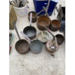 A LARGE ASSORTMENT OF CAST IRON AND COPPER PANS TO ALSO INCLUDE A COPPER KETTLE