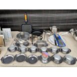 A LARGE ASSORTMENT OF KITCHEN ITEMS TO INCLUDE STAINLESS STEEL TRAYS, A GRILL PAN AND A LAZY SUSAN