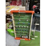 A VINTAGE TABLE SOCCER GAME - ONE PLAYER HAS LOST HIS HEAD, WIDTH 45CM, LENGTH APPROX 89CM
