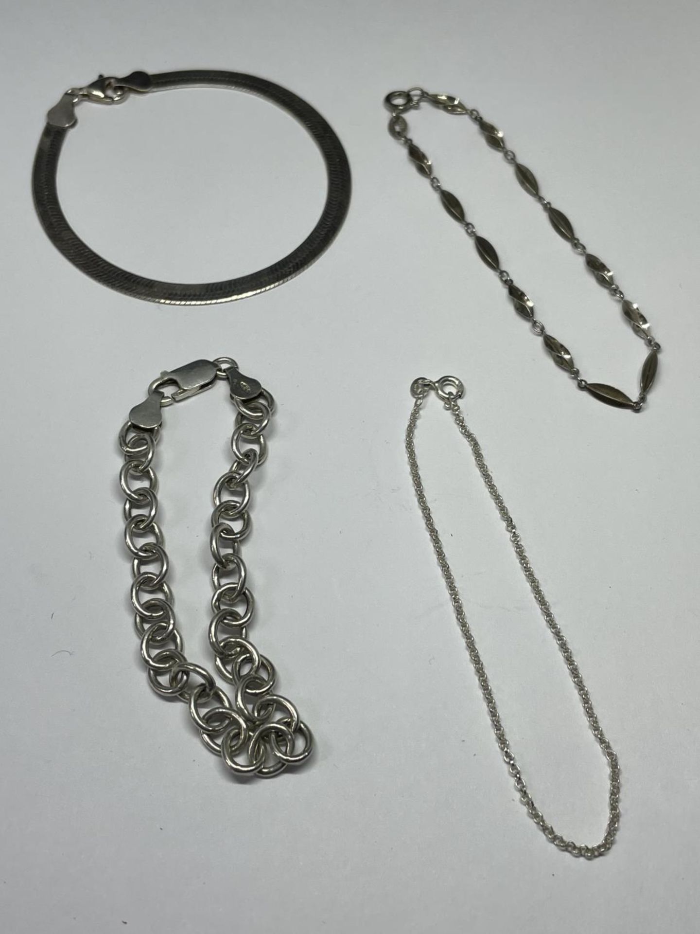 FOUR VARIOUS SILVER BRACELETS