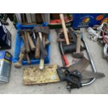 A LARGE ASSORTMENT OF TOOLS TO INCLUDE HAMMERS, AN AXE AND SAWS ETC